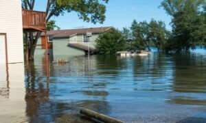 Residential neighborhood with partially flooded homes illustrating the importance of an elevation certificate for flood risk and mortgage protection.