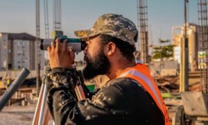 Land surveyor reviewing site conditions during a due diligence survey for a commercial property