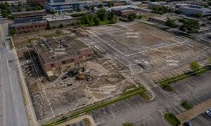 Aerial view of a redevelopment site with survey mapping overlay showing existing site conditions