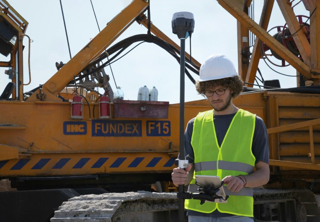 Land surveyor on construction site - ALTA SURVEY Kentucky Land surveyor in Bowling Green KY using GPS equipment on a construction site