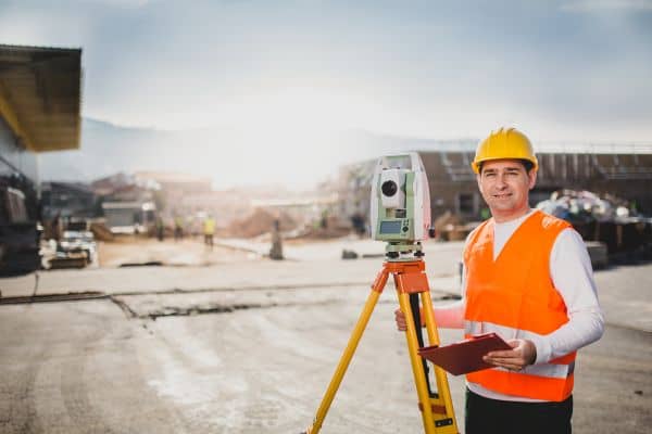 alta surveyor bowling green commercial site - ALTA SURVEY Kentucky Licensed surveyor in safety gear using a total station at a commercial redevelopment site in Bowling Green, KY.