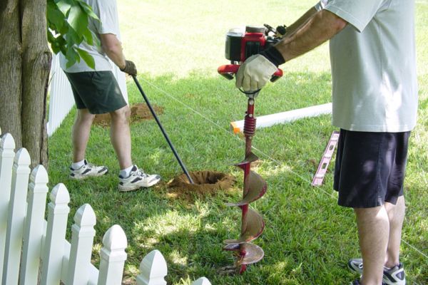 Workers preparing fence installation after a boundary survey in Bowling Green to ensure correct property lines

