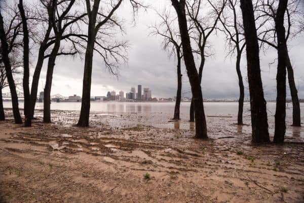 Flooded riverbank in Louisville, Kentucky showing high water levels and urban flood risk