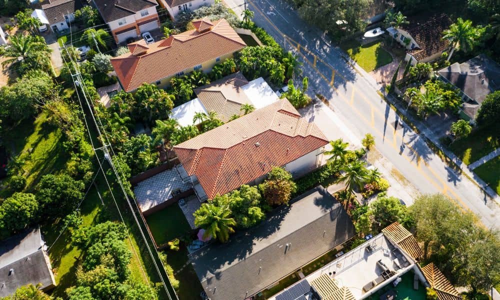 Drone land surveying aerial view showing residential properties and clear property boundaries for accurate land data.
