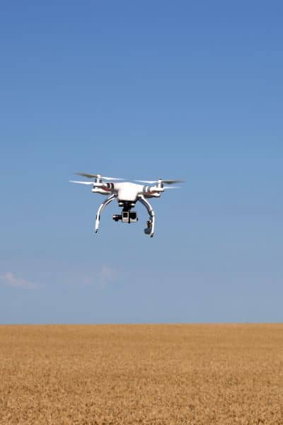 Drone used in a property survey to capture aerial images and detect sinkhole risks in open land

