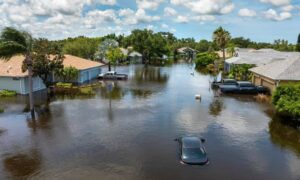 Flooded neighborhood aerial view - ALTA SURVEY Kentucky Aerial view of a suburban neighborhood flooded after heavy rain, showing why homeowners rely on a flood elevation survey to assess property risk