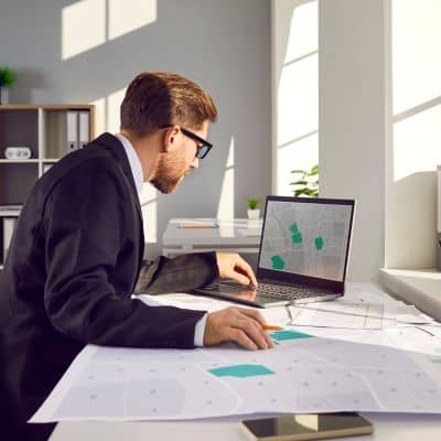 Survey map and records being reviewed as part of boundary line surveys for documenting legal property limits
