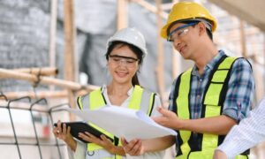 Team reviewing construction plans - ALTA SURVEY Kentucky Surveyor and engineer reviewing plans on site, showing how construction surveys guide early project planning