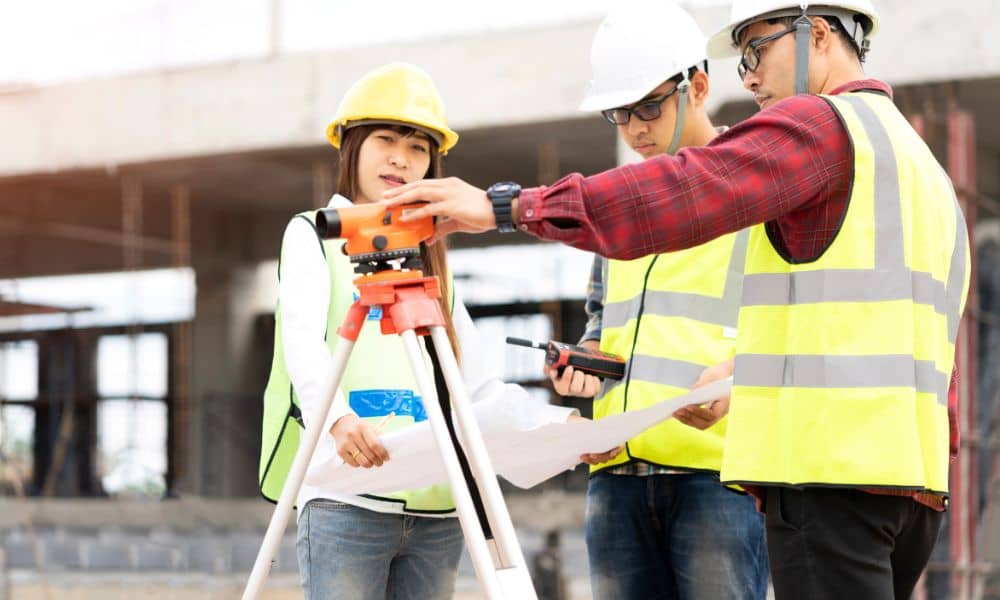 Surveyors reviewing site plans before an alta land survey