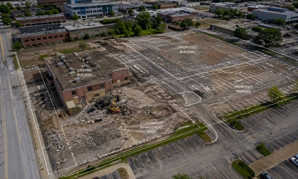 Aerial view of a redevelopment site with survey mapping overlay showing existing site conditions